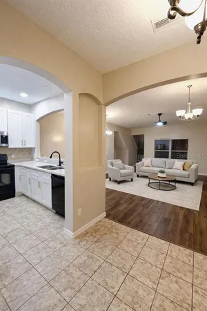 a large kitchen with kitchen island a sink stainless steel appliances and cabinets