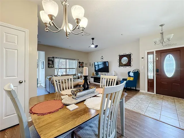 a living room with furniture a dining table and wooden floor