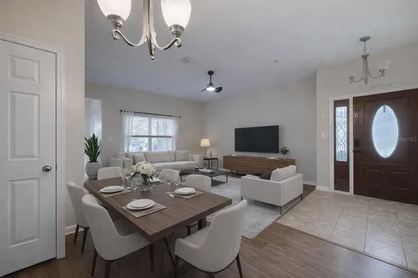 a living room with furniture a window and a flat screen tv