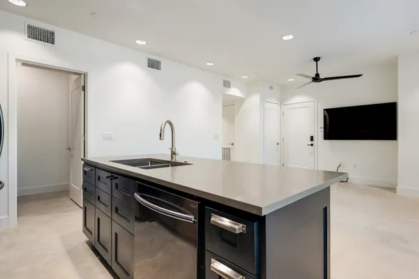a kitchen with stainless steel appliances a sink and a microwave