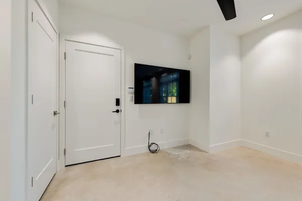 a view of a livingroom with wooden floor and windows