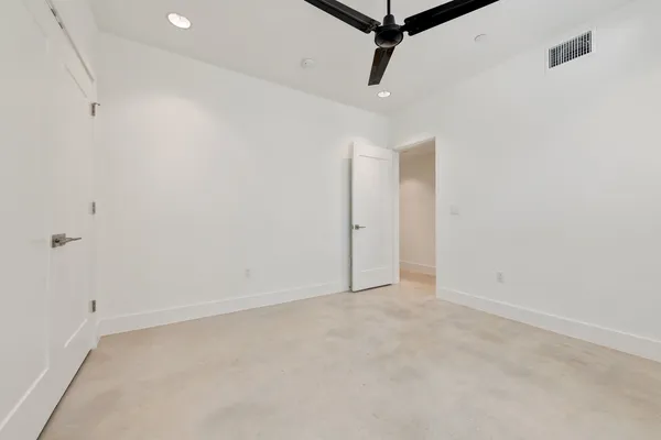 an empty room with a ceiling fan