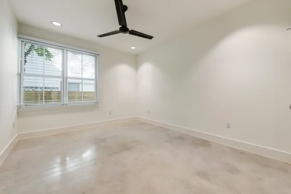 a view of a white house with a small yard and large tree