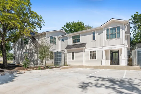 a front view of a house with a road
