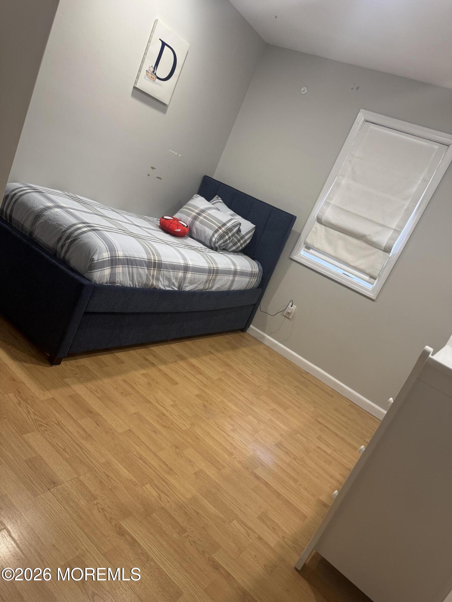 286 Cummings Avenue Long Branch, NJ 07740 - Photo 4 of 6 a bed sitting in a bedroom next to a window