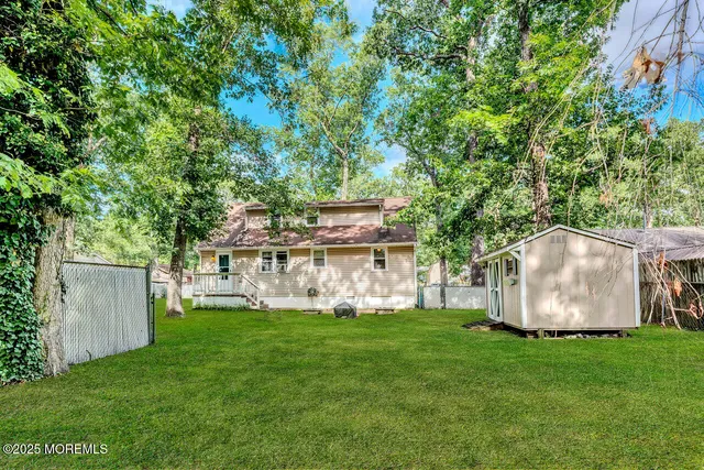 a view of a house with backyard and a sitting area