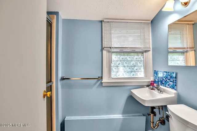 a bathroom with a sink a bath tub and a window