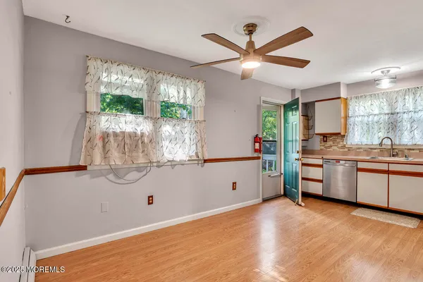a kitchen with stainless steel appliances granite countertop a sink window and a refrigerator