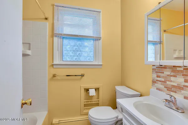 a white toilet sitting next to a bathroom sink
