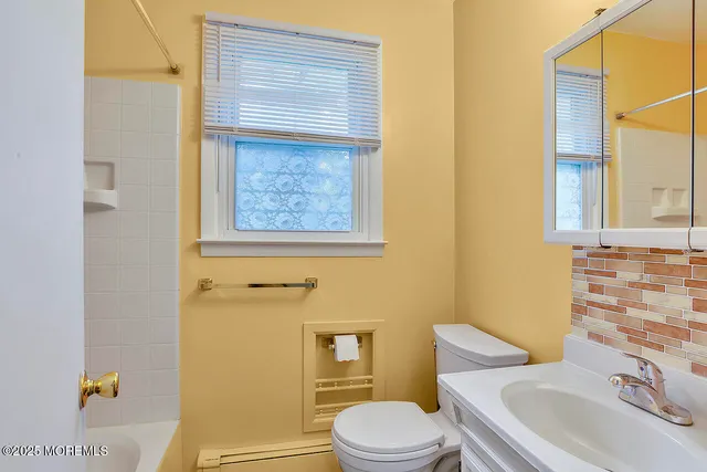 a white toilet sitting next to a bathroom sink