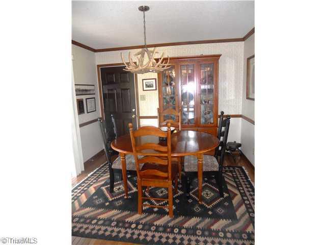 2254 Cullen Road Gibsonville, NC 27249 - Photo 6 of 16 Dining Room. Eat in breakfast area with hardwood floors, Cabela deer antler light fixture, french doors that open to screened porch
