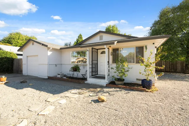 a view of a house with a yard covered in snow