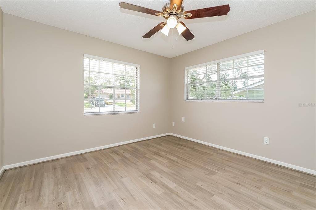 12345 Mayberry Road Spring Hill, FL 34609 - Photo 12 of 16 a view of an empty room with wooden floor and a window