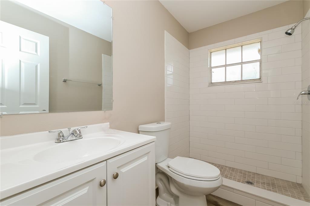 12345 Mayberry Road Spring Hill, FL 34609 - Photo 14 of 16 a bathroom with a sink a toilet and a mirror