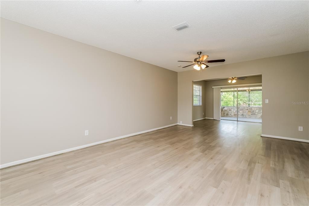 12345 Mayberry Road Spring Hill, FL 34609 - Photo 4 of 16 wooden floor in an empty room with a window