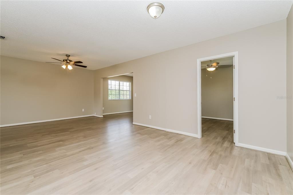 12345 Mayberry Road Spring Hill, FL 34609 - Photo 5 of 16 wooden floor in an empty room with a window