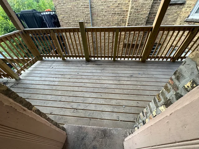 a view of balcony with wooden floor