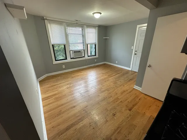 wooden floor in an empty room with a window