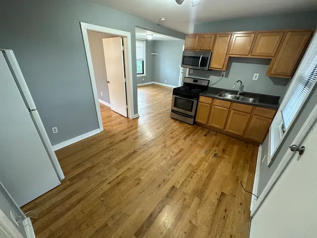 a kitchen with granite countertop a sink stove and refrigerator