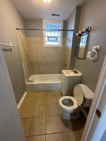 a bathroom with a toilet a sink and a shower