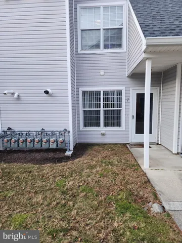 a view of a house with a yard and sitting space