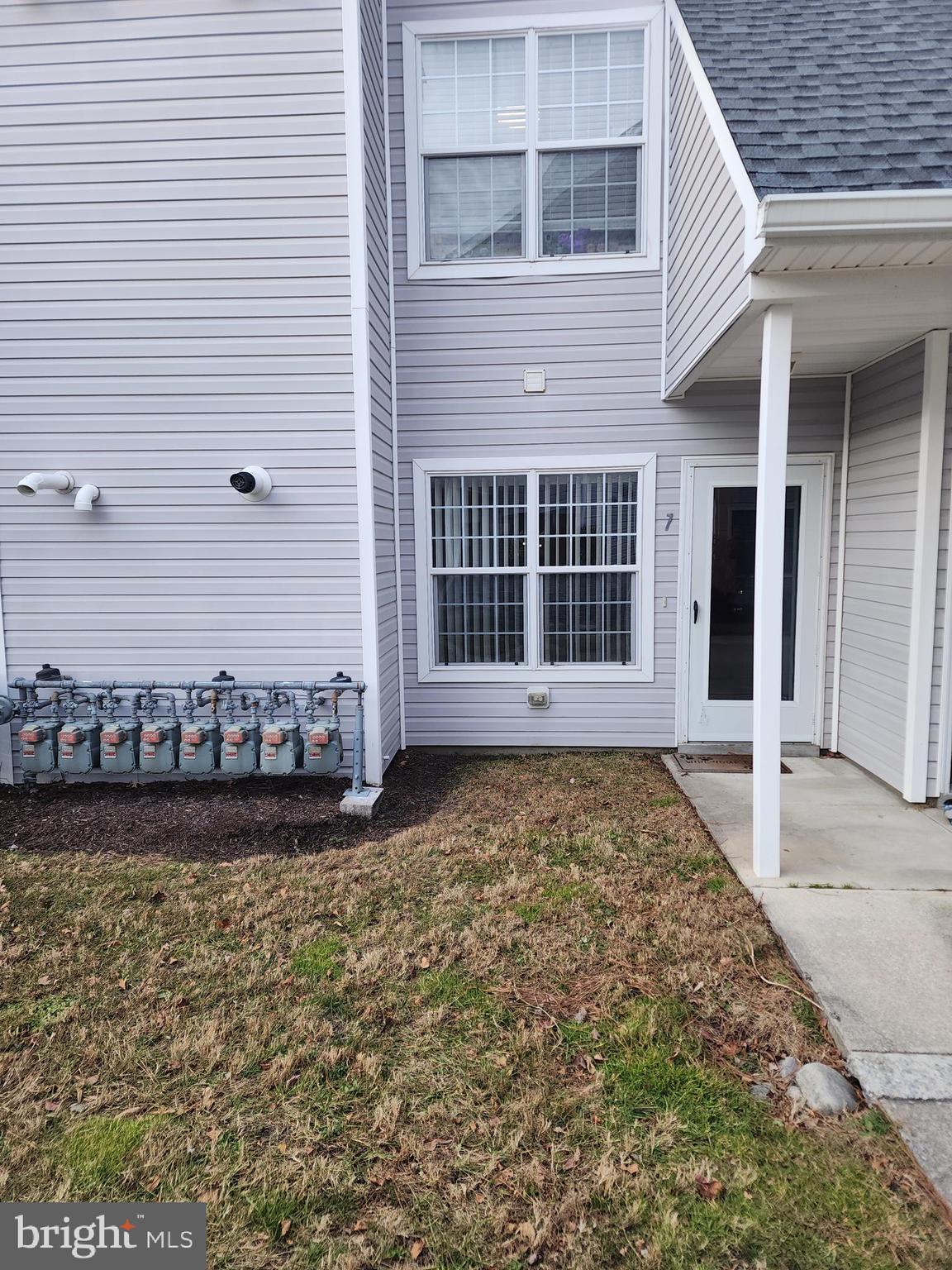a view of a house with a yard and sitting space