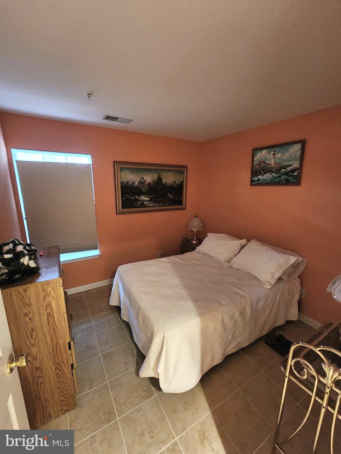 11427 Manklin Creek Road, Unit 7 Ocean Pines, MD 21811 - Photo 11 of 17 a bedroom with a bed and a dresser