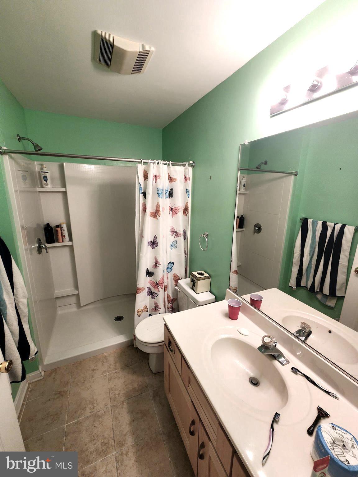 11427 Manklin Creek Road, Unit 7 Ocean Pines, MD 21811 - Photo 12 of 17 a bathroom with a sink mirror and toilet