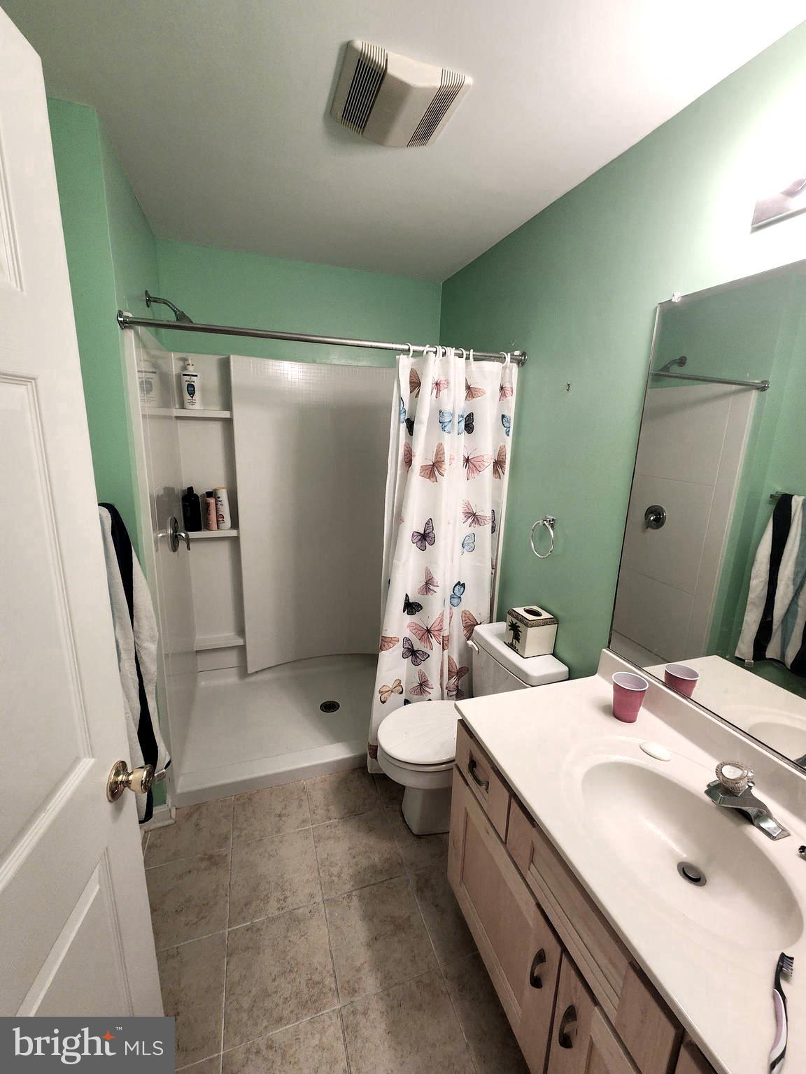 11427 Manklin Creek Road, Unit 7 Ocean Pines, MD 21811 - Photo 13 of 17 a bathroom with a sink a toilet and shower