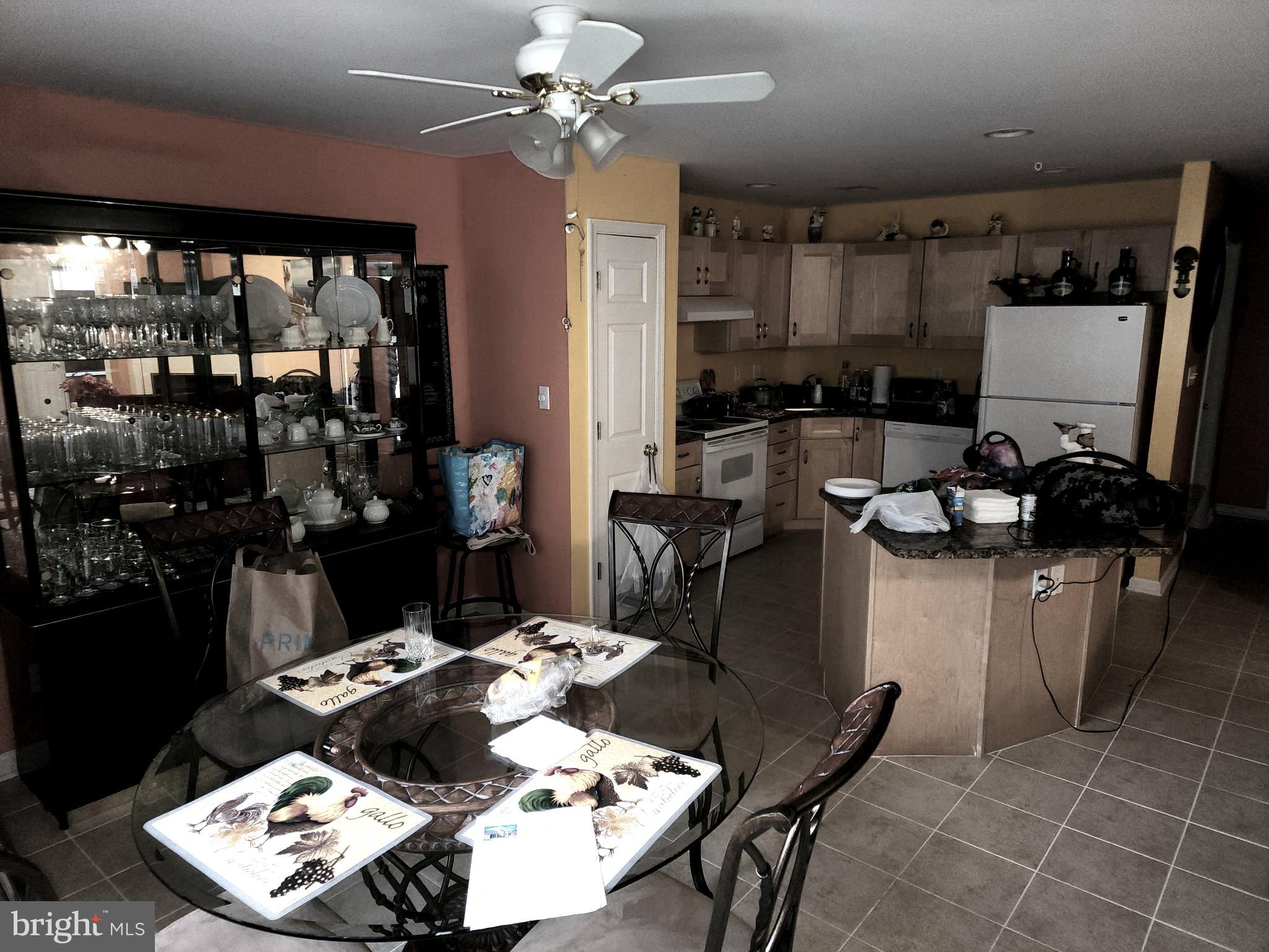 11427 Manklin Creek Road, Unit 7 Ocean Pines, MD 21811 - Photo 15 of 17 a kitchen with a table and chairs in it