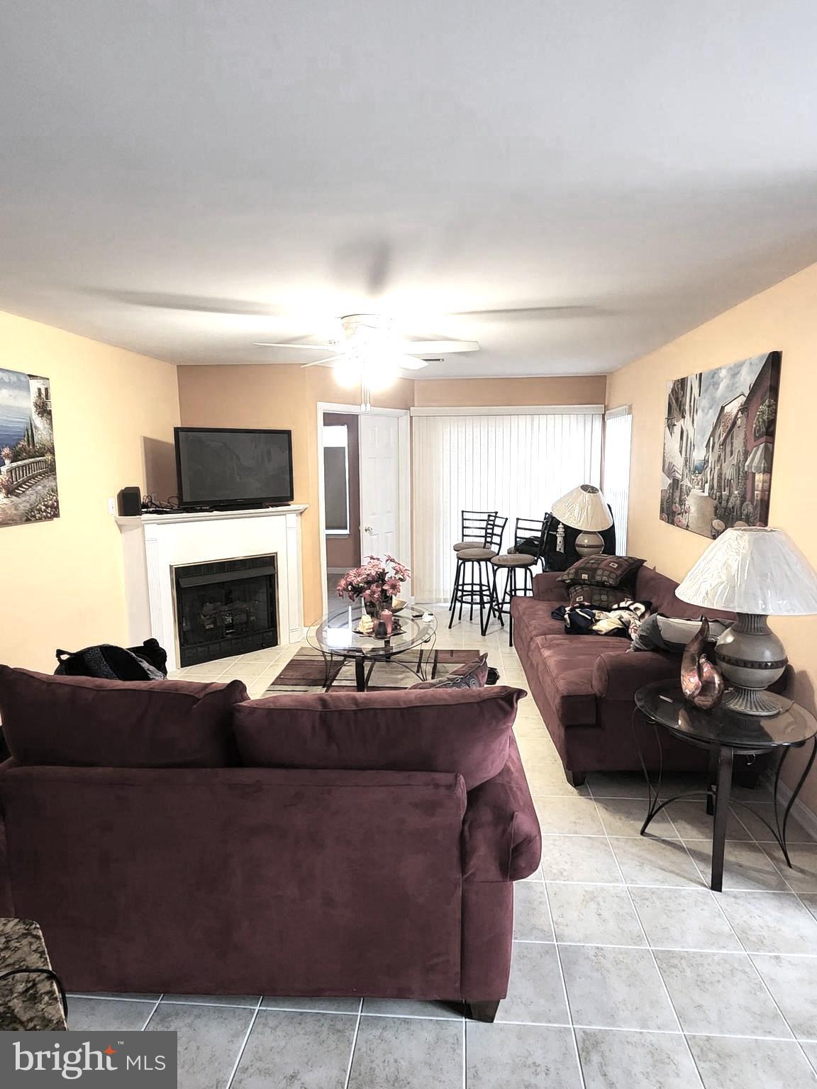 11427 Manklin Creek Road, Unit 7 Ocean Pines, MD 21811 - Photo 4 of 17 a living room with furniture and a fireplace