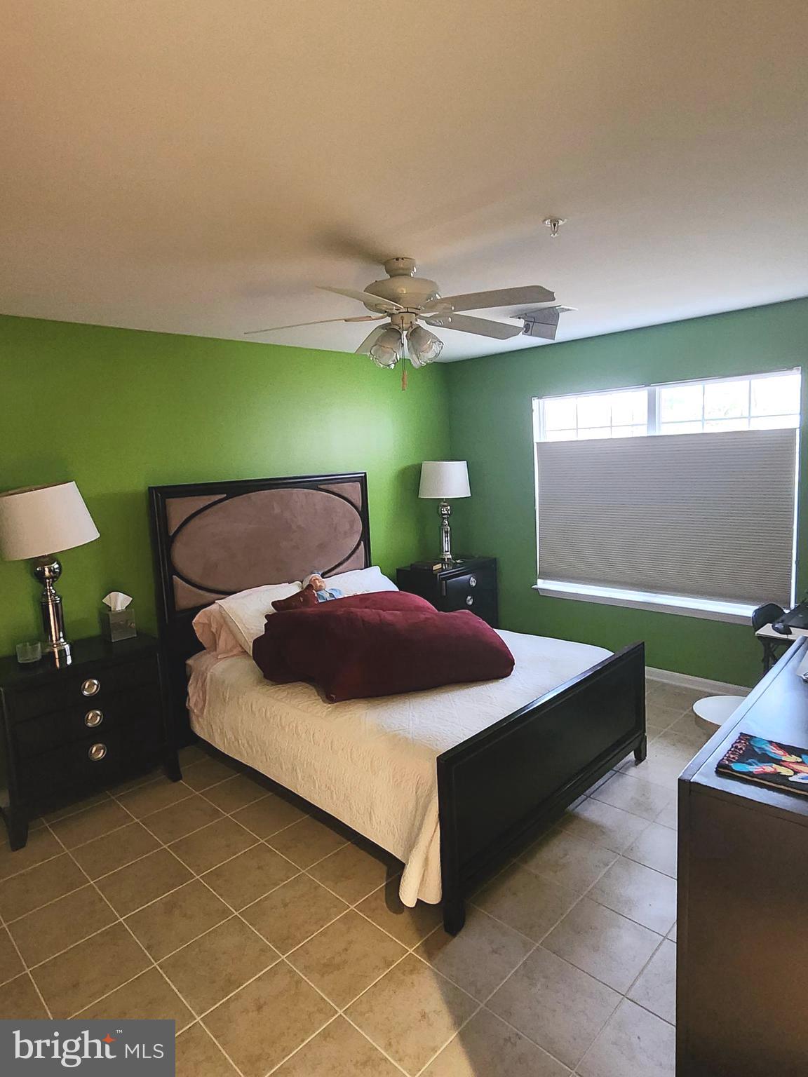 11427 Manklin Creek Road, Unit 7 Ocean Pines, MD 21811 - Photo 8 of 17 a bedroom with a bed and a chandelier