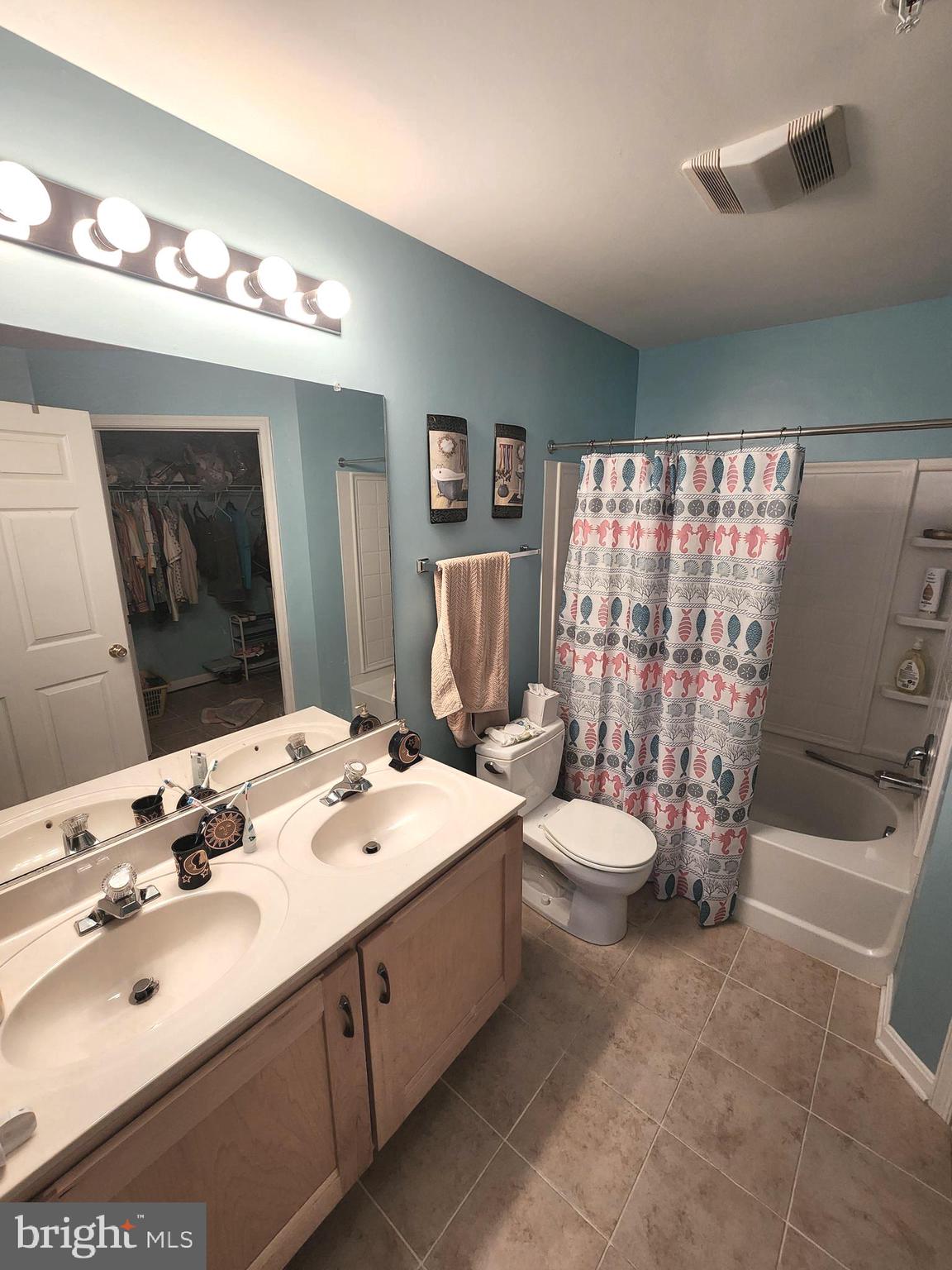 11427 Manklin Creek Road, Unit 7 Ocean Pines, MD 21811 - Photo 9 of 17 a bathroom with a double vanity sink toilet and shower