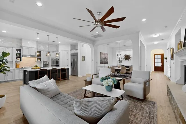 a living room with furniture and kitchen view