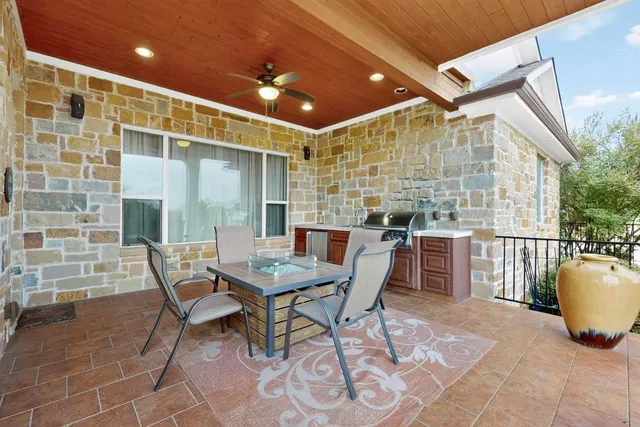 a view of a dinning table and chairs in the patio