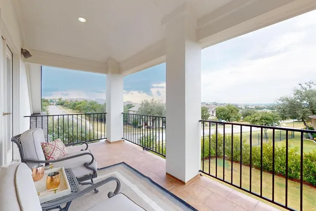 a balcony with furniture and a garden