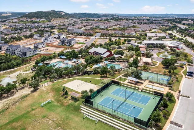 an aerial view of a residential houses with city view