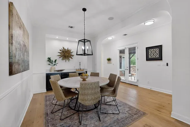 a view of a dining room with furniture wooden floor and chandelier