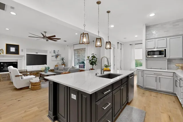a kitchen with a stove refrigerator and microwave