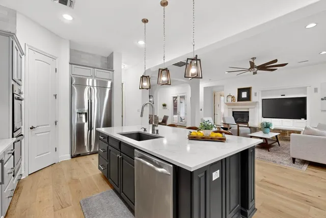 a kitchen with a sink a counter top space and stainless steel appliances