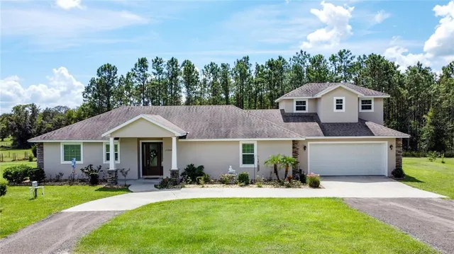 a front view of a house with a yard and garage