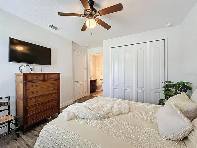 a living room with furniture kitchen view and a chandelier
