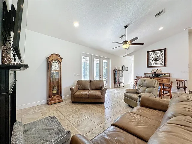 a kitchen with stainless steel appliances kitchen island granite countertop a kitchen island and chairs in it