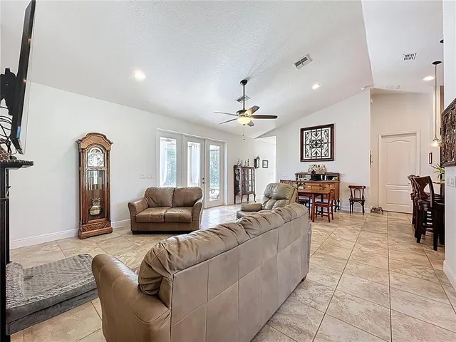 a kitchen with stainless steel appliances granite countertop wooden cabinets a sink a stove a refrigerator and a stove