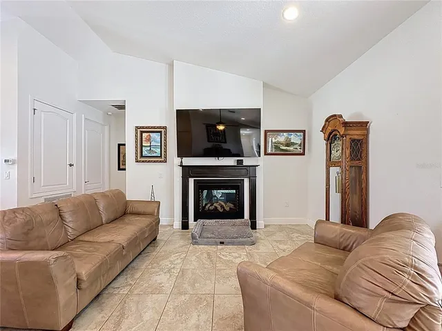a view of a patio with a table and chairs under an umbrella