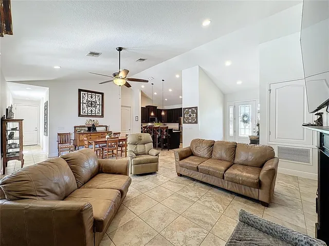 a bedroom with a large bed and a ceiling fan