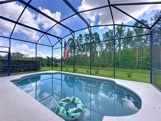 a view of a swimming pool with an outdoor space and seating