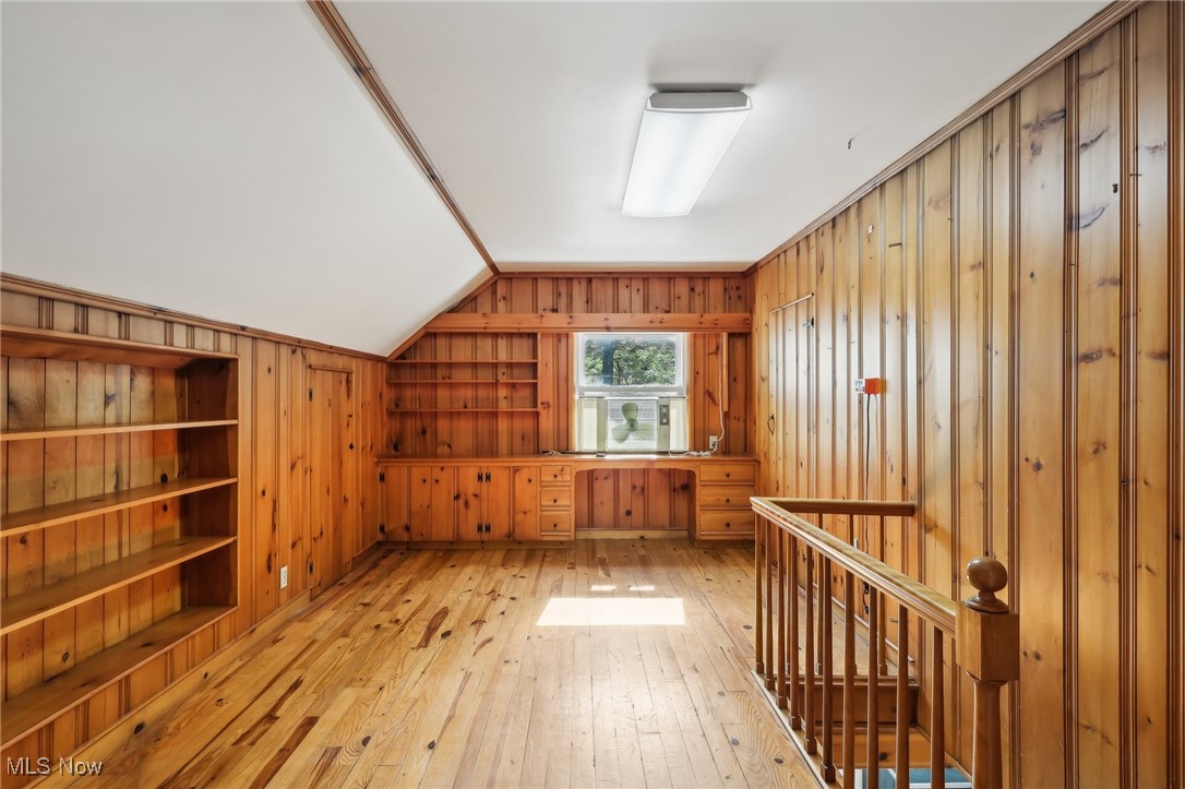 1042 Renfield Road Cleveland Heights, OH 44121 - Photo 24 of 49 Additional living space featuring light wood-type flooring, vaulted ceiling, built in features, and wooden walls