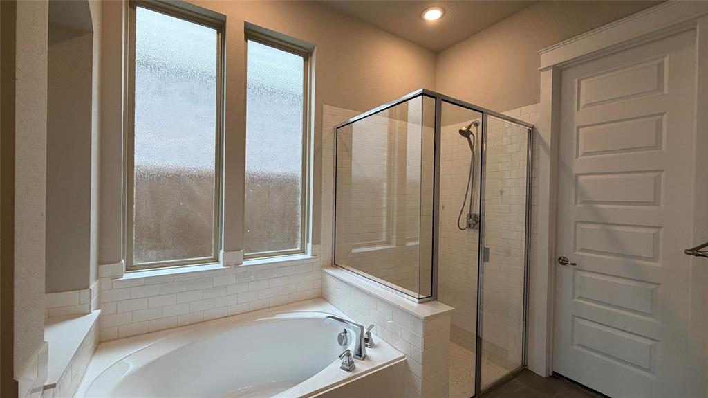 912 Fallbrook Avenue Denton, TX 76210 - Photo 11 of 26 a bathroom with a bathtub and a shower