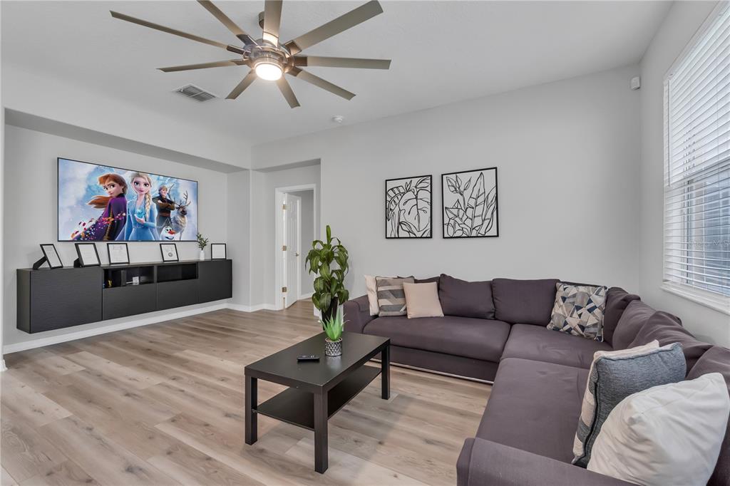 506 Kettering Road Davenport, FL 33897 - Photo 12 of 45 a living room with furniture and a flat screen tv